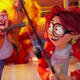 A smiling Katie Mitchell and her father run from an explosion and evil robot, her mom and brother close behind.